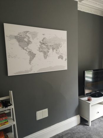 push-pin-world-map-customer-photo-grey-man-on-grey-wall