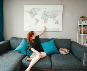 push-pin-world-map-customer-photo-grey-white-over-grey-sofa