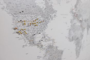 push-pin-world-map-customer-photo-grey-with-golden-pins