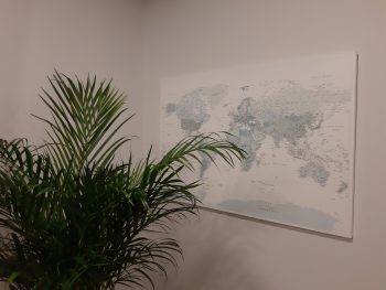 push-pin-world-map-customer-photo-sky-blue-on-grey-wall-scaled